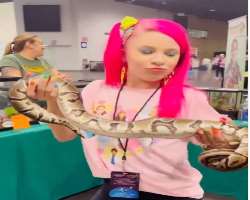 She is a brave girl and doesn't afraid of holding a scary python.